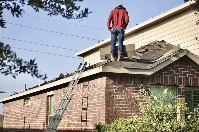 Professional roofer working on a residential roof in Strawntown